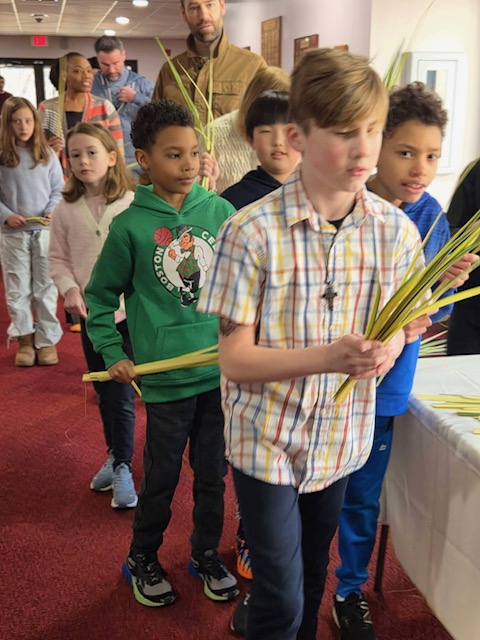 Children carrying palm fronds for Palm Sunday procession