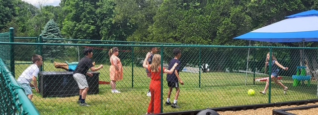 Children playing games on the church playground on a summer day