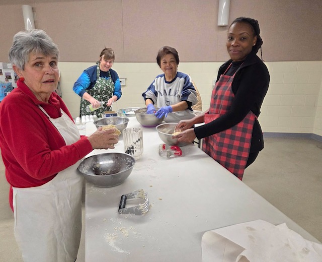 Volunteers preparing chicken pot pies in the church kitchen